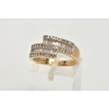 A 9CT GOLD DIAMOND DRESS RING, of a cross over design, set with rectangular cut and single cut