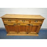 A CORONA PINE SIDEBOARD, with three drawers and triple cupboard doors, width 167cm x depth 46cm x