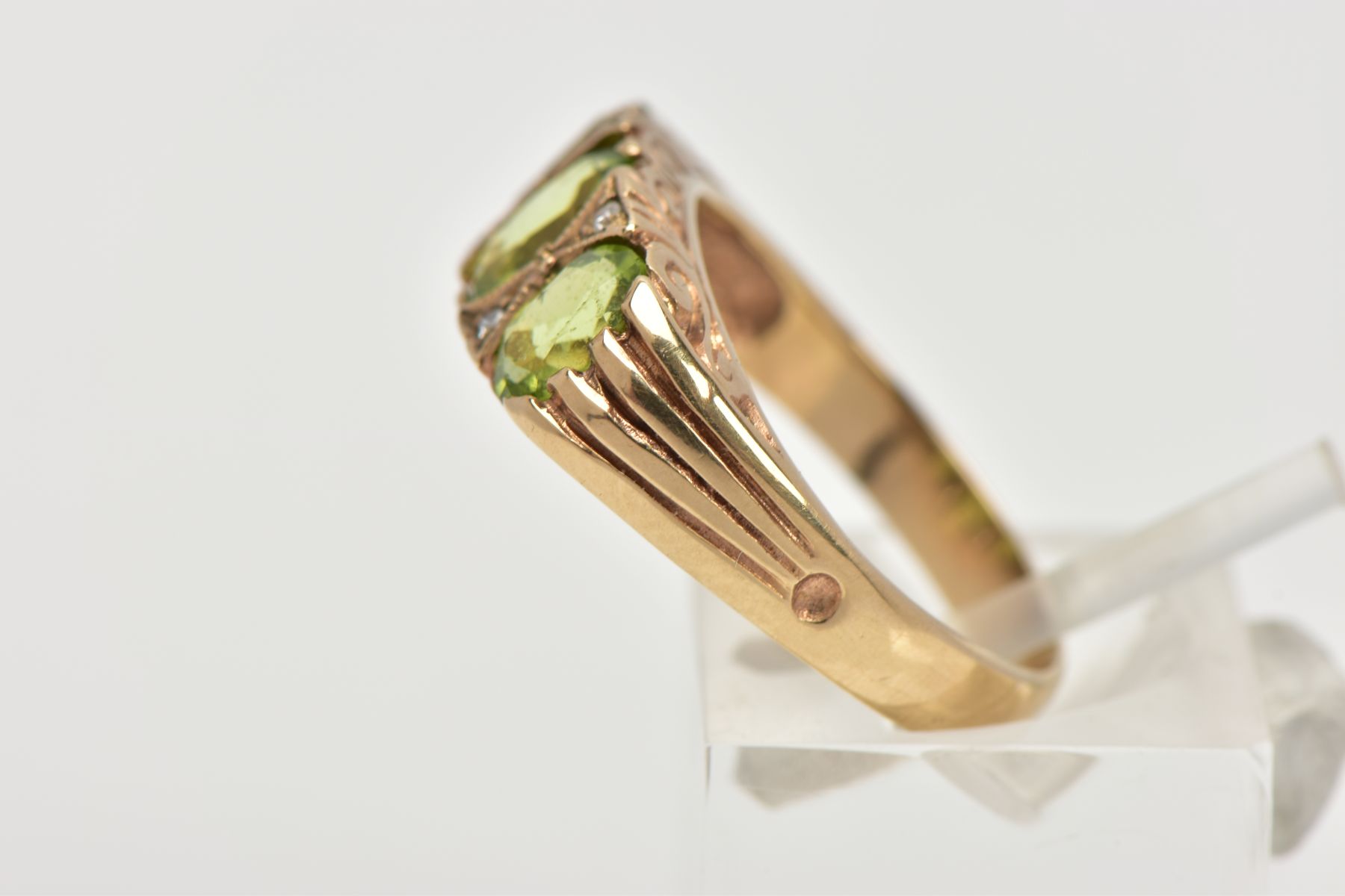 A MODERN 9CT GOLD SEVEN STONE DRESS RING, designed with three oval cut peridots, interspaced with - Image 2 of 4