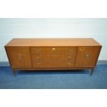 A GREAVES AND THOMAS 1960'S TEAK SIDEBOARD, with double cupboard doors flanking three drawers, the