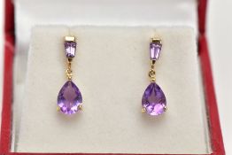 A PAIR OF YELLOW METAL AMETHYST DROP EARRINGS, each designed with a claw set, pear cut amethyst