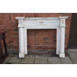 A 20TH CENTURY ADAMS STYLE FIRE SURROUND constructed from distressed white painted oak with robe