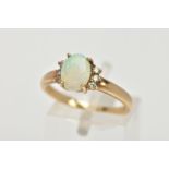 A 9CT GOLD OPAL AND DIAMOND RING, centring on a four claw set oval white opal cabochon, showing