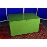 A GREEN OVERPAINTED PINE TOOL CHEST, cast iron handles to the sides, lacking interior fittings and