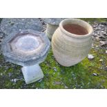 A LARGE TERRACOTTA COLOURED PLANT POT of balustered shape, height 63cm, and a bird bath in brickwork