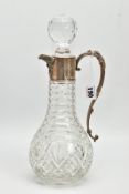 A SILVER MOUNTED GLASS CLARET JUG, Bacchus face to the collar, fitted with a scrolling handle