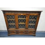 AN OAK LEAD GLAZED TRIPLE DOOR BOOKCASE, with three cupboard doors, on bracket feet, width 163cm x