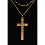A YELLOW METAL CROSS PENDANT, a large cross detailing a scrolling foliage pattern, approximate
