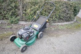 A KINGFISHER INTERNATIONAL PETROL LAWN MOWER with a Briggs and Statton 450e 125cc engine and grass