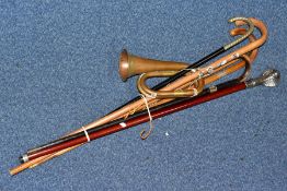 SIX WALKING STICKS/ CANES AND A COPPER AND BRASS BUGLE, the walking sticks to include two with white