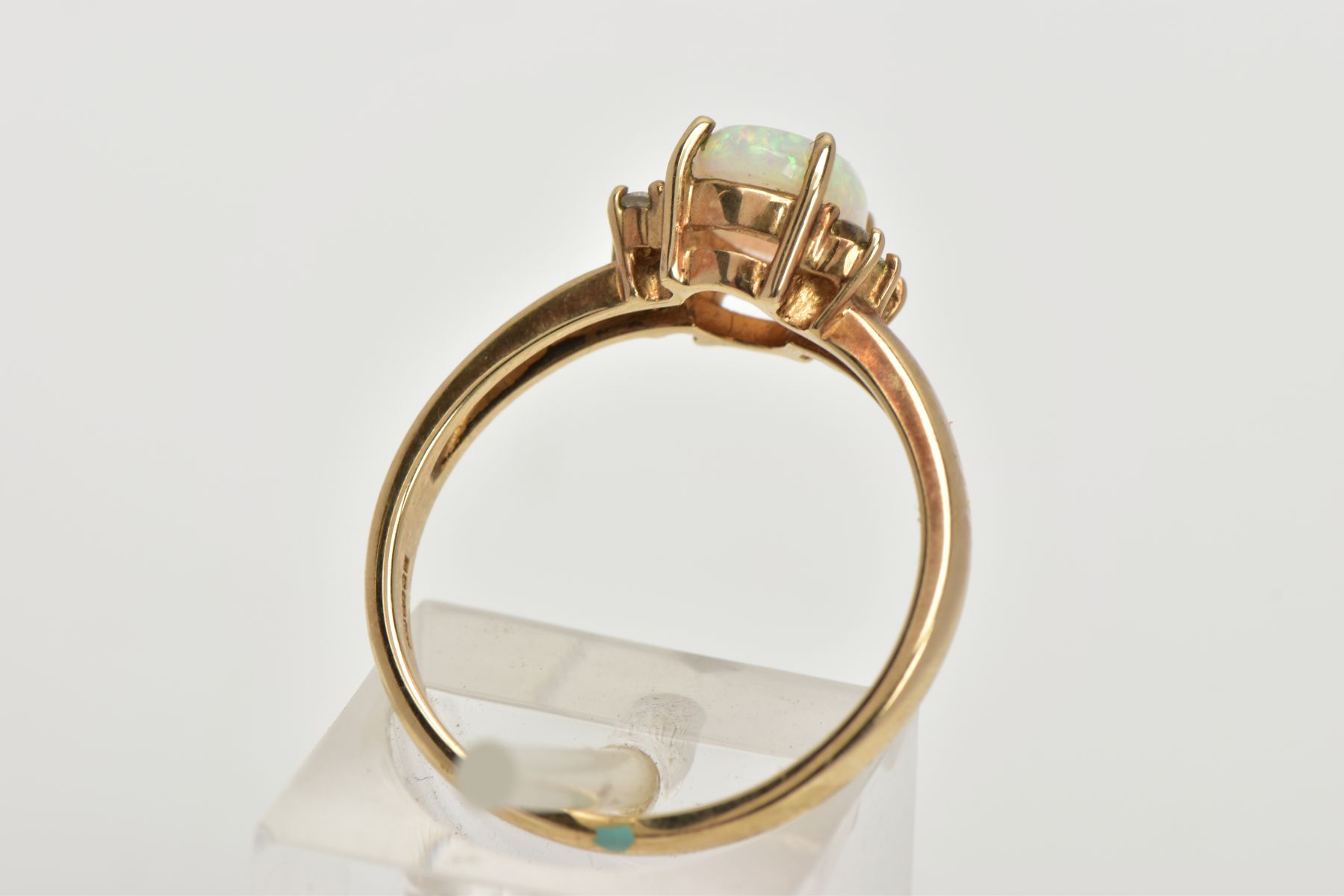 A 9CT GOLD OPAL AND DIAMOND RING, centring on a four claw set oval white opal cabochon, showing - Image 3 of 4