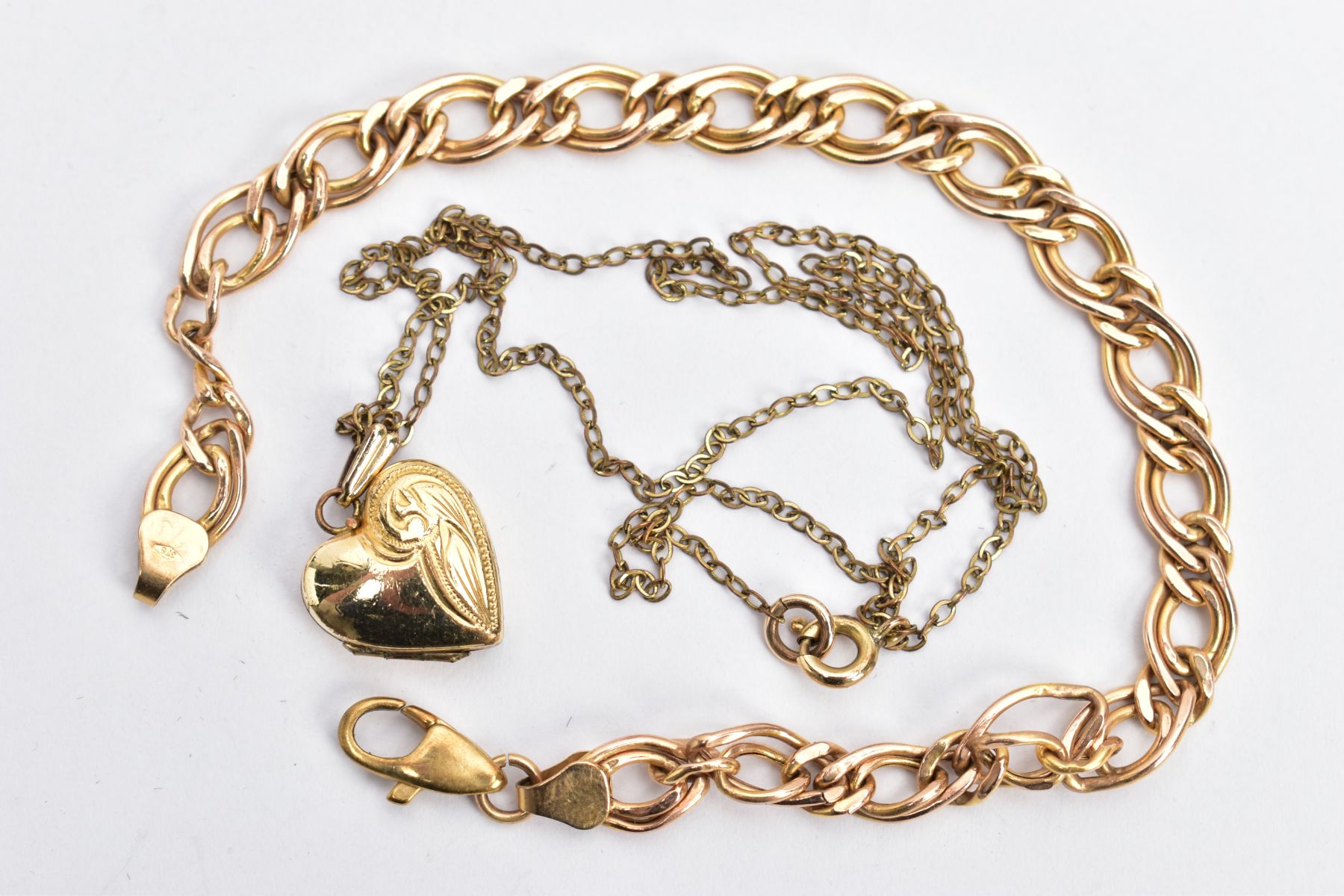 A 9CT GOLD BRACELET AND A HEART LOCKET PENDANT NECKLACE, the double curb link bracelet, fitted