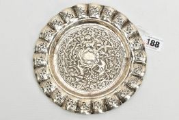 AN INDIAN WHITE METAL TRAY, of a circular form, decorated to the centre with an embossed forest