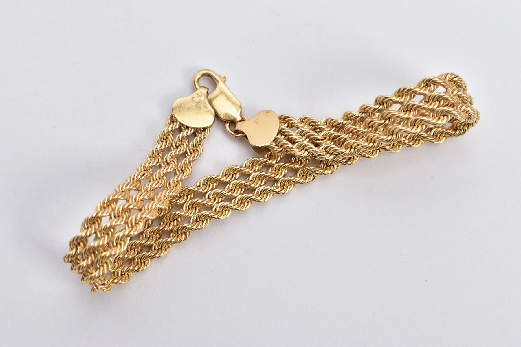 A 9CT GOLD BRACELET, designed as a triple row of rope twist chains, fitted with a lobster claw - Image 2 of 2