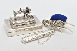 THREE WHITE METAL ITEMS, to include a silver sewing needle box fitted with a sewing machine to the