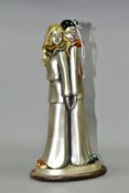 A SILVER LAMINATED FIGURE GROUP, comprising a male and female clown standing back to back, silver