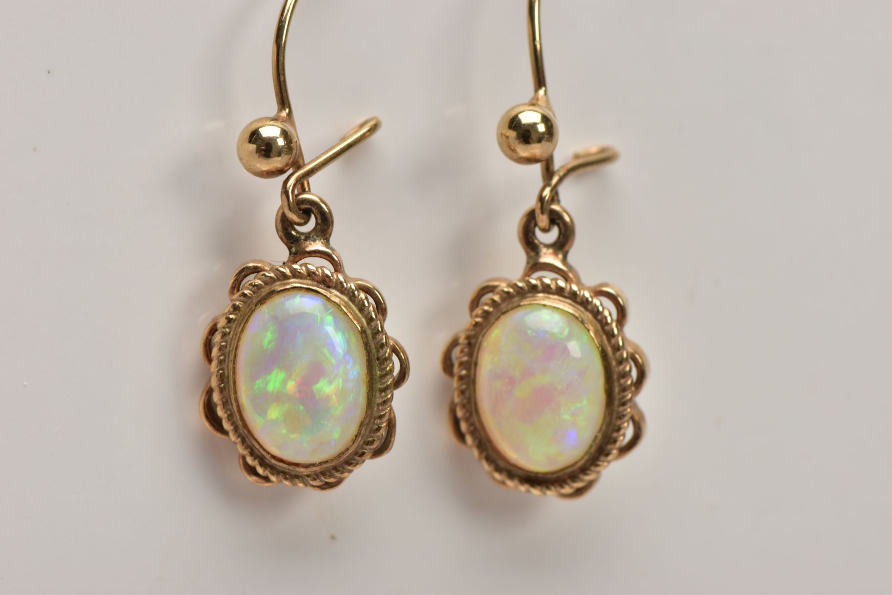 A PAIR OF OPAL CABOCHON DROP EARRINGS, yellow metal drop earrings each of an oval form, oval white - Image 2 of 3