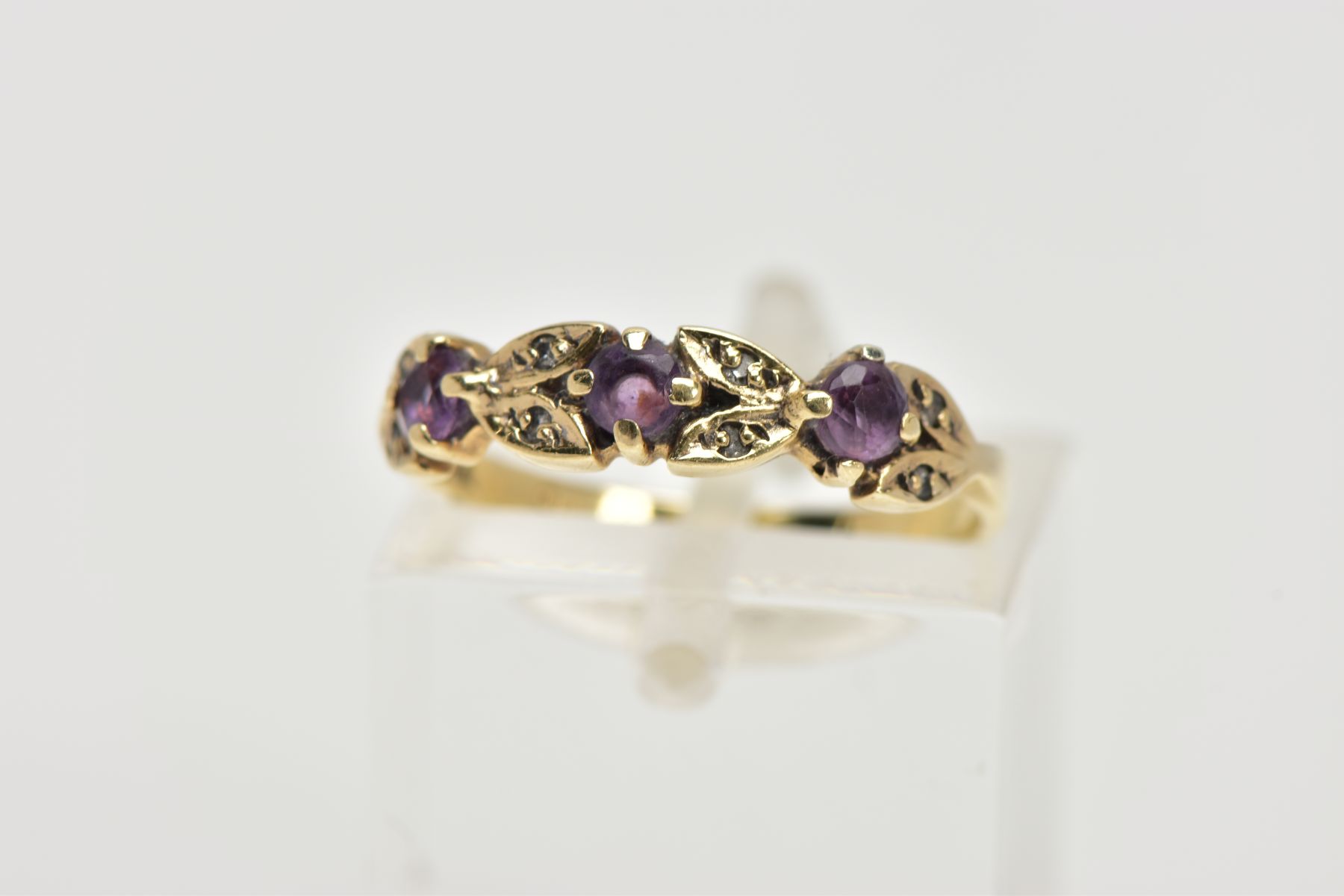A 9CT GOLD AMETHYST AND DIAMOND RING, half eternity style ring, set with three circular cut