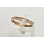 A 9CT GOLD DIAMOND HALF ETERNITY RING, designed with a row of channel set single cut diamonds,