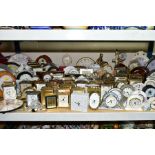 A QUANTITY OF CARRIAGE, MANTEL, ANNIVERSARY AND WALL CLOCKS, to include more than ninety, mainly