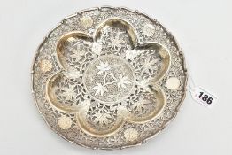 AN INDIAN PIERCED WHITE METAL BONBON DISH, of a circular form, wavy detailed rim, pierced foliate