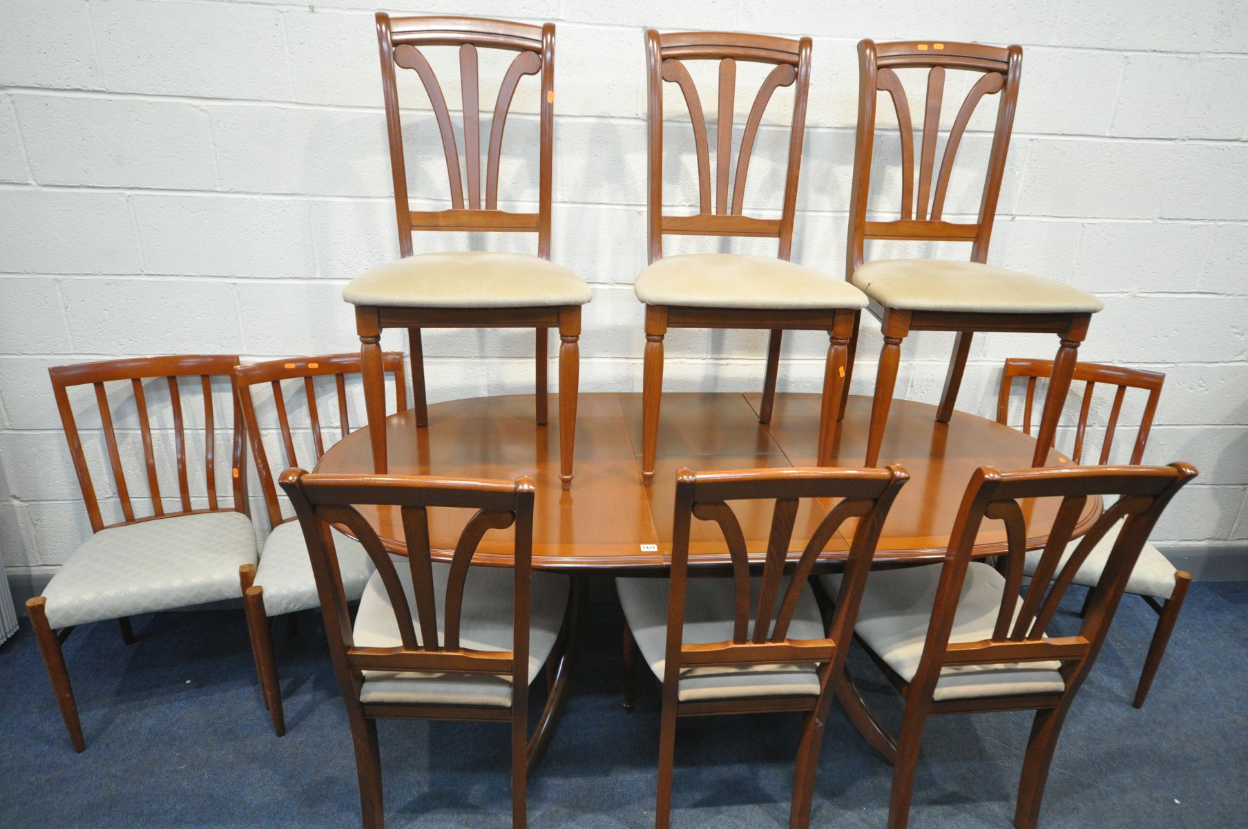 A MORRIS FURNITURE CO EXTENDING DINING TABLE, with a single additional fold out leaf, extended