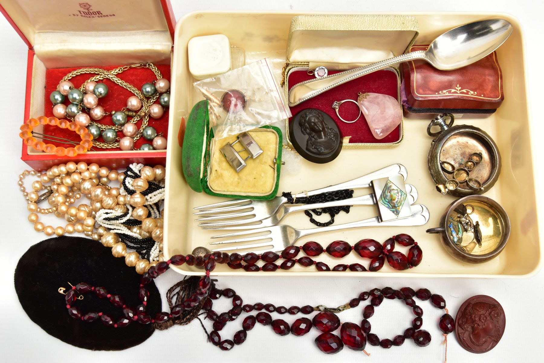 A BOX OF ASSORTED ITEMS, to include a white metal citrine set cross pendant, a carved ivory book