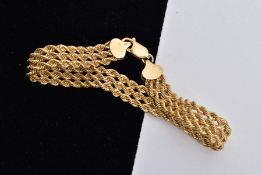 A 9CT GOLD BRACELET, designed as a triple row of rope twist chains, fitted with a lobster claw