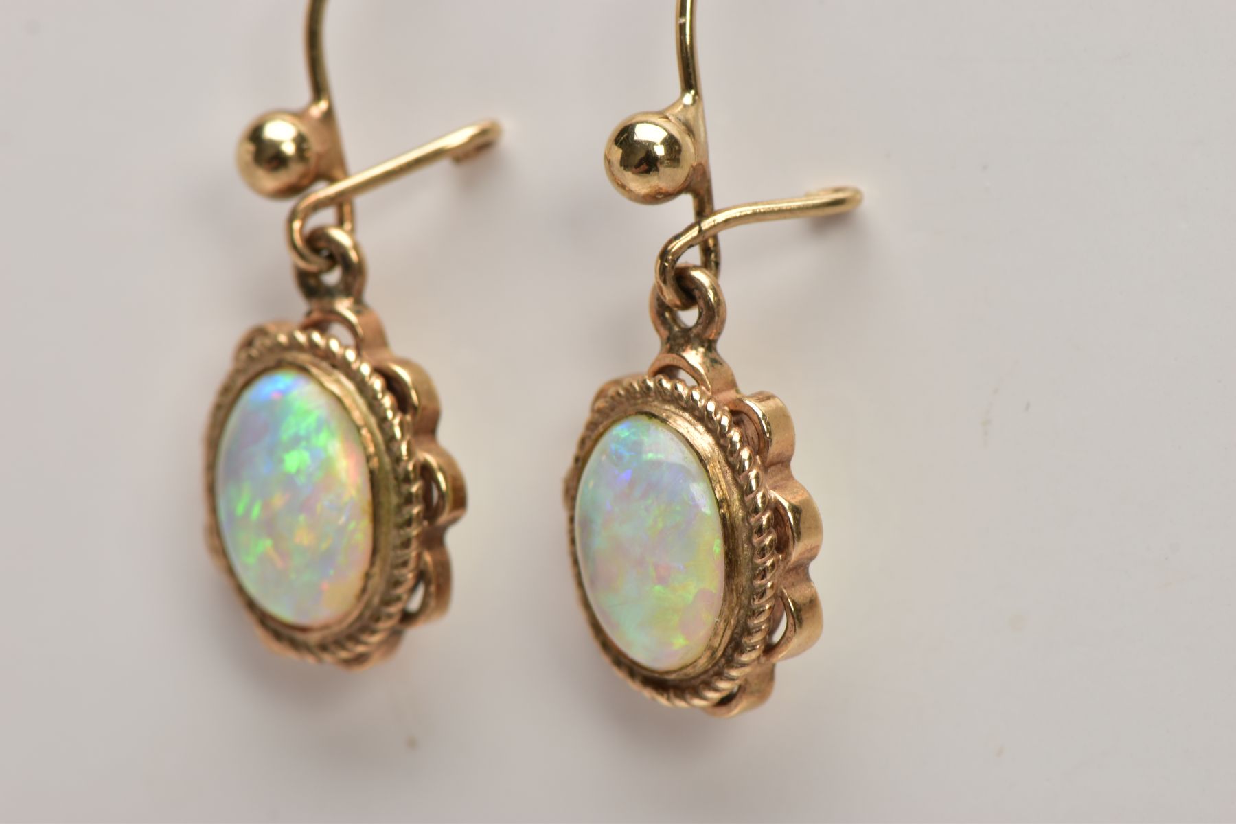 A PAIR OF OPAL CABOCHON DROP EARRINGS, yellow metal drop earrings each of an oval form, oval white - Image 3 of 3