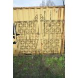 A PAIR OF WROUGHT IRON DRIVEWAY GATES, with fifteen scrolling Quatrefoils to each gate, overall