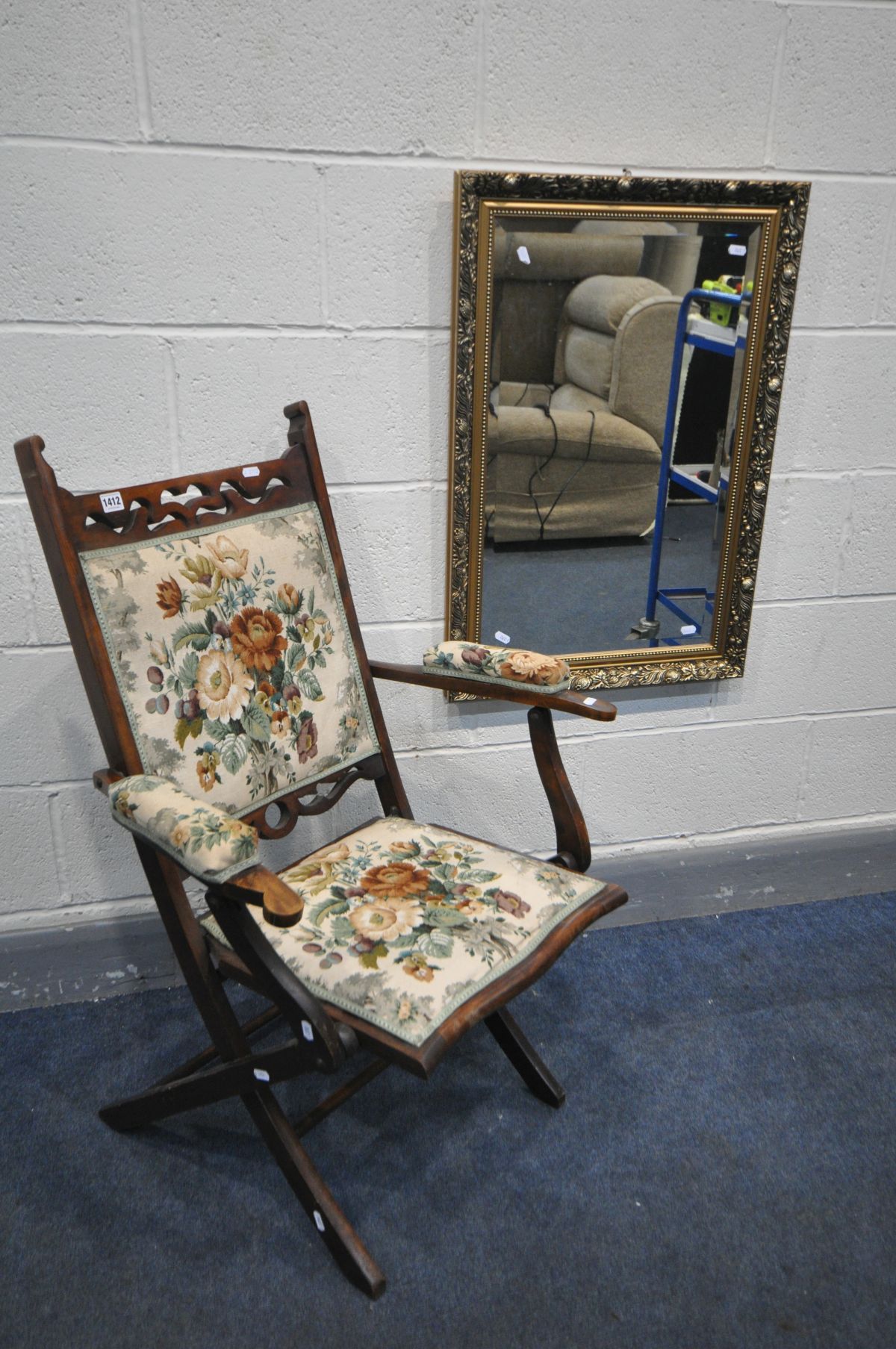 AN EARLY 20TH CENTURY BEECH FOLDING ARMCHAIR, with open armrests, along with a gilt wood bevelled