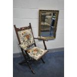 AN EARLY 20TH CENTURY BEECH FOLDING ARMCHAIR, with open armrests, along with a gilt wood bevelled