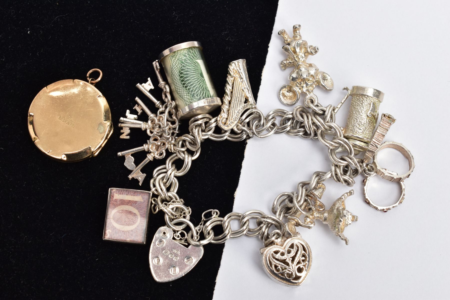 A SILVER CHARM BRACELET AND A LOCKET, the double curb link bracelet, some links stamped with a - Image 2 of 2