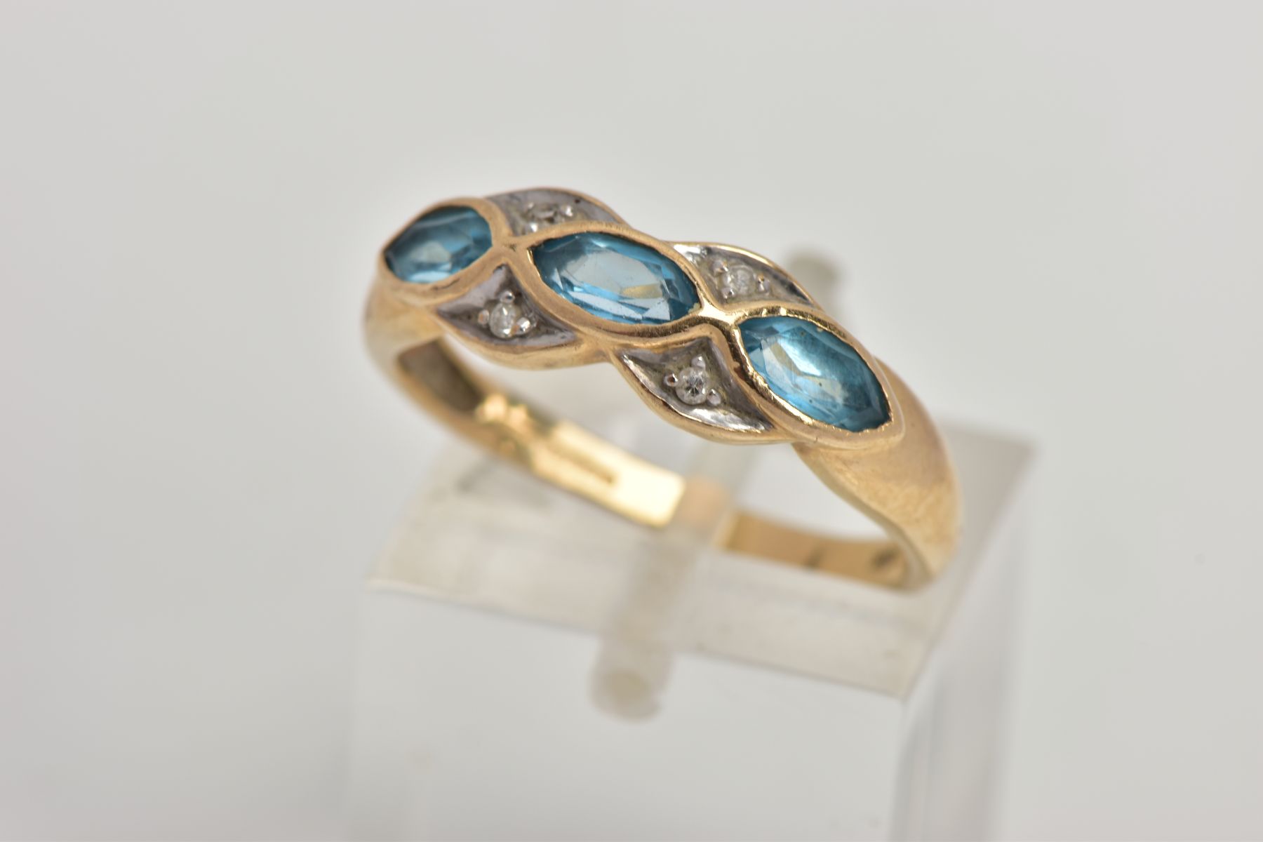 A 9CT GOLD TOPAZ AND DIAMOND RING, half eternity ring set with three marquise cut blue topaz each