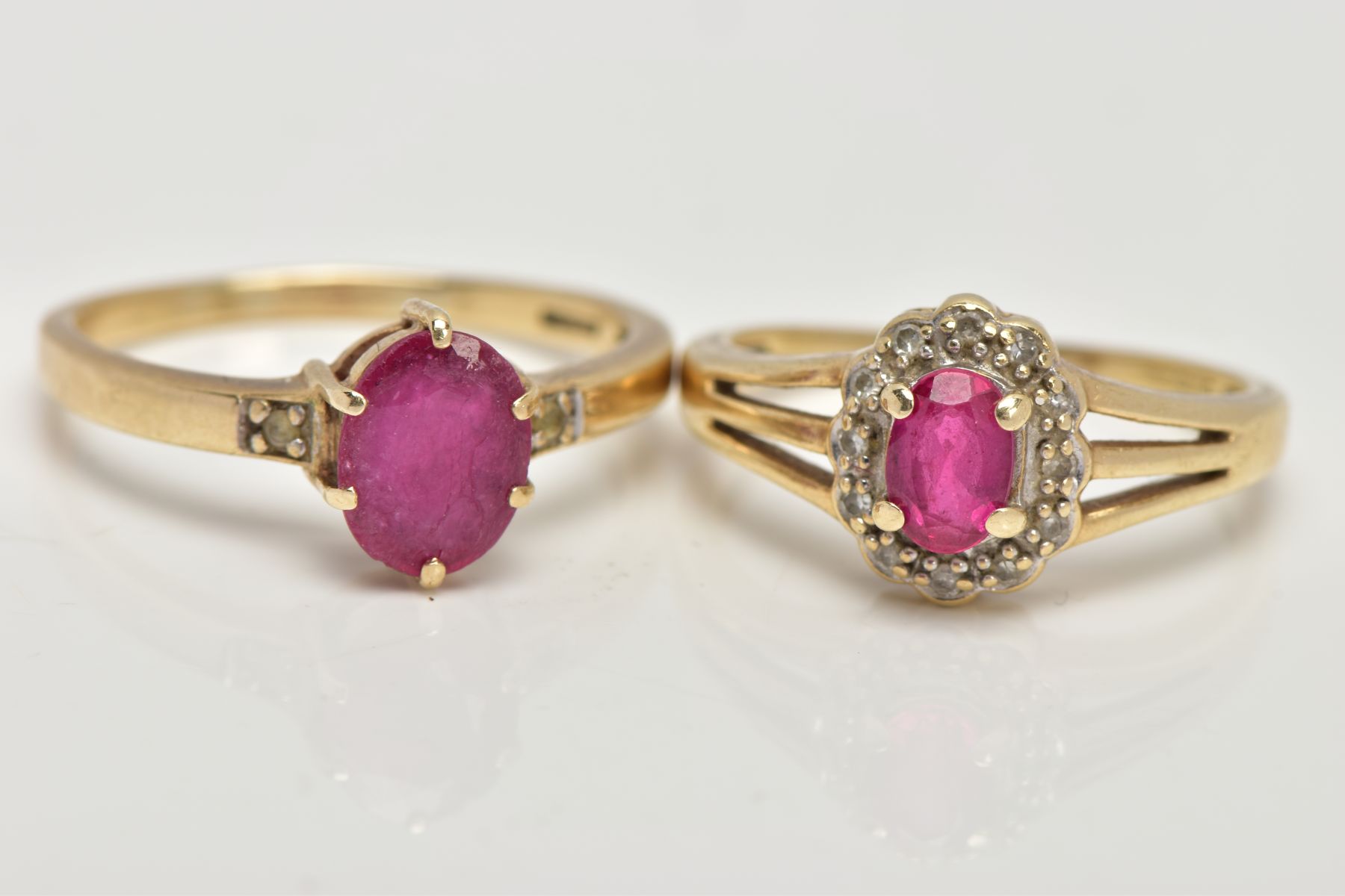 TWO 9CT GOLD GARNET RINGS, the first designed with a six claw set, oval cut ruby (low quality,