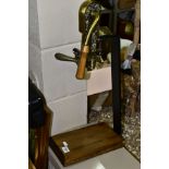 A MODERN ESTATE TABLE TOP BOTTLE OPENER, wooden base and handle, cast vine design, height