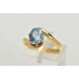 AN 18CT GOLD AQUAMARINE RING, an oval cut aquamarine, approximate dimensions length 8mm x width 6mm,