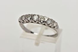 AN 18CT WHITE GOLD DIAMOND RING, designed with a row of seven round brilliant cut diamonds,