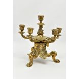 A LATE VICTORIAN BRASS SIX LIGHT CANDLESTICK IN REGENCY STYLE, cast with acanthus, rams heads,