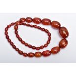 A BAKELITE BEADED NECKLACE, graduating oval beads, orange/brown in colour, fitted with a bead