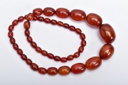 A BAKELITE BEADED NECKLACE, graduating oval beads, orange/brown in colour, fitted with a bead