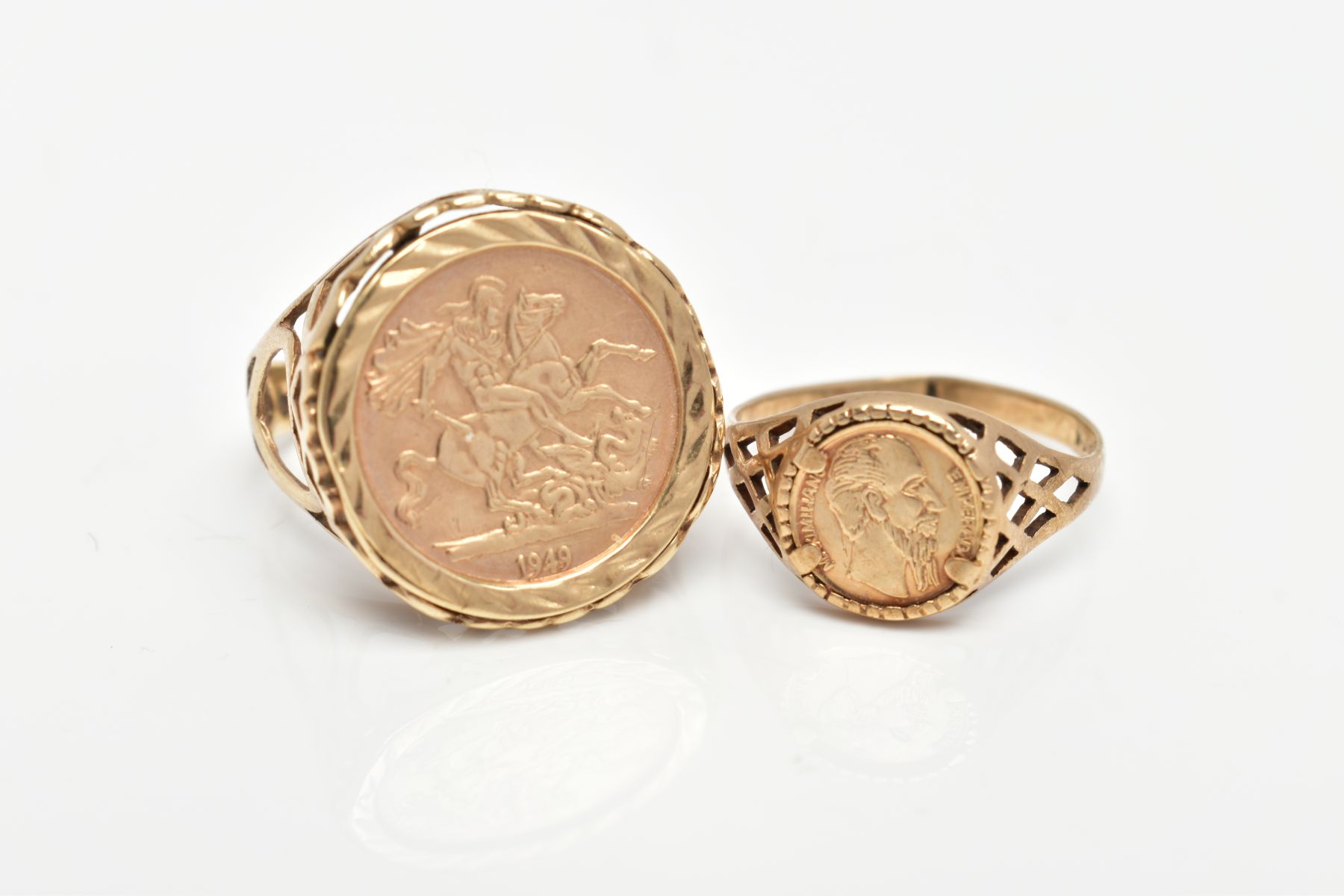 TWO 9CT GOLD COIN RINGS, both with pierced detail to the shoulders, one set with an imitation