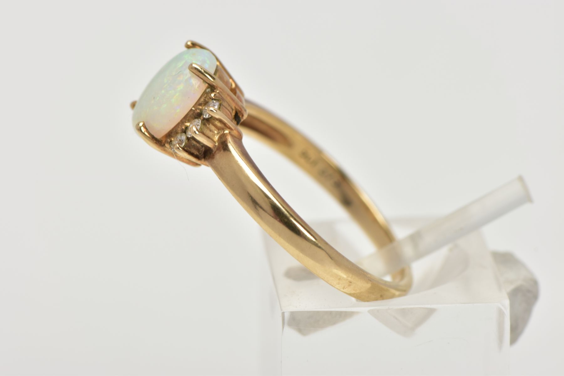 A 9CT GOLD OPAL AND DIAMOND RING, centring on a four claw set oval white opal cabochon, showing - Image 2 of 4