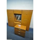 A TEAK EFFECT THREE SECTION BEDROOM FITMENT, comprising two double door wardrobes flanking a central