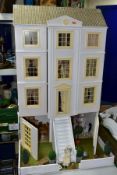 A LARGE MODERN WOODEN DOLLS HOUSE, modelled as a three storey Georgian style house with basement,