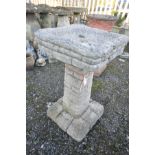 A COMPOSITE BIRD BATH in the form of a brickwork detail base and top, height 77cm