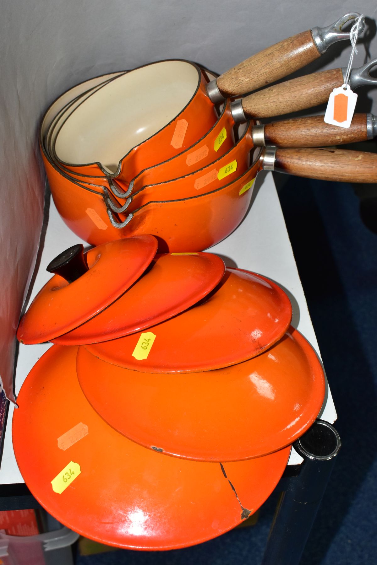 A GRADUATED SET OF FOUR LE CREUSET ORANGE ENAMEL SAUCEPANS AND LIDS, wooden handles, pouring lips, - Image 2 of 6