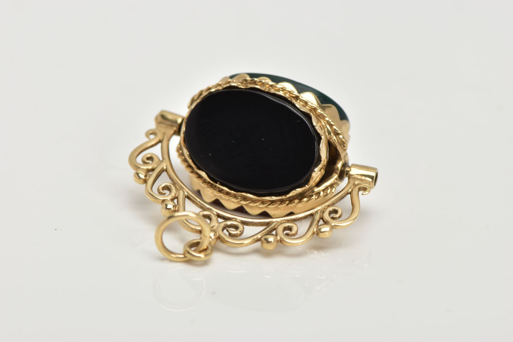 A 9CT GOLD SWIVEL FOB, set with oval cut onyx, carnelian and bloodstone panels, openwork scroll - Image 3 of 4