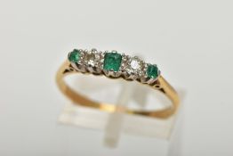 AN EMERALD AND DIAMOND FIVE STONE RING, an emerald cut emerald set centrally with two round