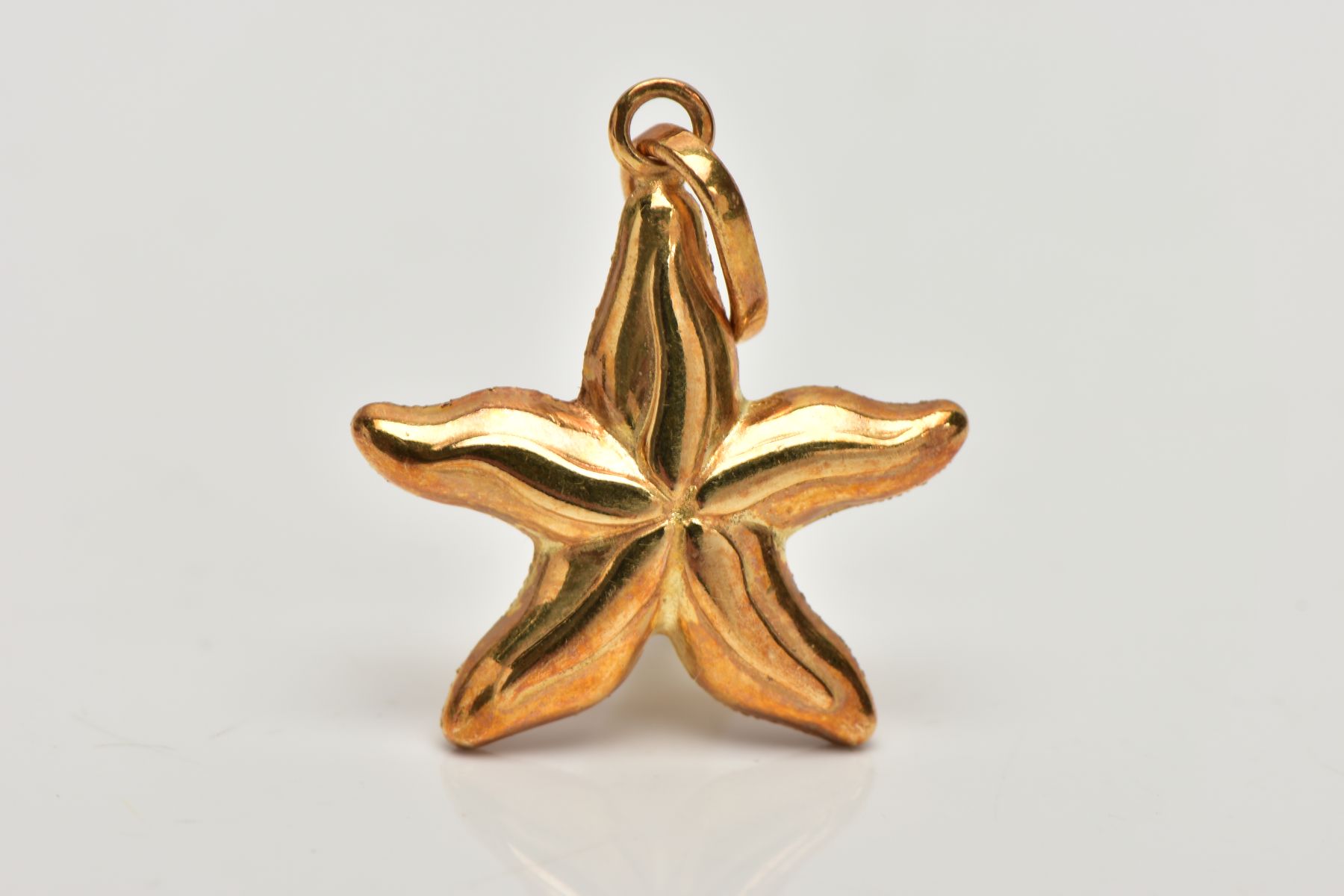 A YELLOW METAL STARFISH PENDANT, a textured yellow metal hollow pendant in the form of a starfish, - Image 2 of 2